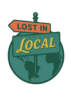 A vintage-style circular logo for "Lost in Local" featuring a stylized Earth in muted green with contrasting dark green continents. A retro directional signpost stands in front of the globe, displaying two signs: one orange with the words "LOST IN" in bold uppercase letters, and another in teal with the word "LOCAL" in yellow retro script. The overall color palette is warm and adventurous, evoking travel and cultural exploration.
